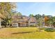 Beautiful two-story brick home with a metal roof and large front yard at 3820 Gnarled Oaks Ln, Johns Island, SC 29455