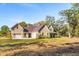 Brick home with metal roof, attached garage, and covered porch at 3820 Gnarled Oaks Ln, Johns Island, SC 29455