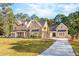 Stunning brick home with metal roof, landscaped yard, and porte-cochère at 3820 Gnarled Oaks Ln, Johns Island, SC 29455