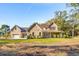 Brick home with metal roof, two-car garage, and landscaped yard at 3820 Gnarled Oaks Ln, Johns Island, SC 29455