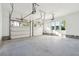 Two-car garage with white doors and concrete floor at 3820 Gnarled Oaks Ln, Johns Island, SC 29455