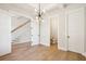 Hallway with hardwood floors, staircase, and access to a powder room at 3820 Gnarled Oaks Ln, Johns Island, SC 29455