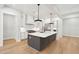 View of the kitchen island with white countertop, gray cabinets, and pendant lighting at 3820 Gnarled Oaks Ln, Johns Island, SC 29455