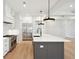 Kitchen island with white quartz countertop, gray cabinets, and stainless steel appliances at 3820 Gnarled Oaks Ln, Johns Island, SC 29455