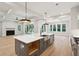 View of the kitchen island with open shelving, overlooking the living area at 3820 Gnarled Oaks Ln, Johns Island, SC 29455