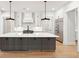 Spacious kitchen featuring an island with white countertop, dark cabinets, and stainless steel appliances at 3820 Gnarled Oaks Ln, Johns Island, SC 29455