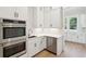 Kitchen features stainless steel double ovens, dishwasher, and white cabinetry at 3820 Gnarled Oaks Ln, Johns Island, SC 29455