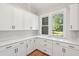 Bright, spacious kitchen with white cabinets, quartz countertops, and a view of the outdoors at 3820 Gnarled Oaks Ln, Johns Island, SC 29455