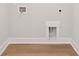 Empty laundry room with hardwood floors and white walls at 3820 Gnarled Oaks Ln, Johns Island, SC 29455