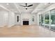 Bright living room with fireplace, hardwood floors, and sliding glass doors at 3820 Gnarled Oaks Ln, Johns Island, SC 29455