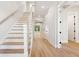 Foyer with wooden staircase, hardwood floors, and white walls at 3820 Gnarled Oaks Ln, Johns Island, SC 29455