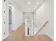 Upstairs hallway with hardwood floors, overlooks staircase to foyer at 3820 Gnarled Oaks Ln, Johns Island, SC 29455
