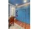 Home office with blue walls, built-in murphy bed and hardwood floors at 29 Broad St # B, Charleston, SC 29401