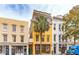 Yellow 3 story building on tree lined street at 29 Broad St # B, Charleston, SC 29401