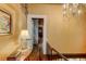 Elegant hallway with exposed brick, hardwood floors, and antique décor at 29 Broad St # B, Charleston, SC 29401