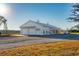 White barn with large garage doors and covered porch at 6500 Parkers Ferry Rd, Adams Run, SC 29426