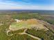 Aerial view of farm with fields, buildings, and wooded areas at 6500 Parkers Ferry Rd, Adams Run, SC 29426