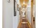 Long hallway with wood flooring and framed artwork leading to other rooms at 6500 Parkers Ferry Rd, Adams Run, SC 29426
