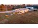 Aerial view of a farmhouse with a firepit and surrounding landscape at 6500 Parkers Ferry Rd, Adams Run, SC 29426