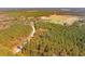 Aerial view of property with long private driveway and surrounding forest at 6500 Parkers Ferry Rd, Adams Run, SC 29426