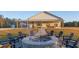 Brick firepit with surrounding seating in the backyard at 6500 Parkers Ferry Rd, Adams Run, SC 29426