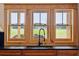 Modern farmhouse sink with a black gooseneck faucet and expansive views at 6500 Parkers Ferry Rd, Adams Run, SC 29426