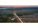 Sunrise aerial view of rural property with pond and fields at 6500 Parkers Ferry Rd, Adams Run, SC 29426