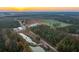 Aerial view of the property showcasing the farm buildings and pond at 6500 Parkers Ferry Rd, Adams Run, SC 29426