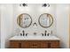 Double vanity bathroom with large circular mirrors at 6500 Parkers Ferry Rd, Adams Run, SC 29426