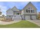 Tan two-story house with grey accents, double garage, and white staircase at 2317 Sunfish Cir, Charleston, SC 29412