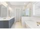 Spa-like bathroom with a soaking tub, double vanity, and glass shower at 1153 Oak Bluff Ave, Charleston, SC 29492