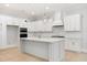 Modern kitchen with white cabinets, large island, and stainless steel appliances at 1153 Oak Bluff Ave, Charleston, SC 29492