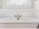 Freestanding white bathtub with elegant brass fixtures at 1153 Oak Bluff Ave, Charleston, SC 29492
