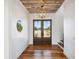 Bright entryway with double doors and rustic hardwood floors at 2545 Anchor Watch Dr, Wadmalaw Island, SC 29487