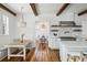 Elegant kitchen features white cabinets, high-end appliances, and exposed wooden beams at 2545 Anchor Watch Dr, Wadmalaw Island, SC 29487