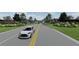 The Groves community entrance with landscaping and homes visible at 4000 Winding Grove Ln, Moncks Corner, SC 29461