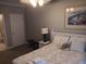 Bedroom with queen bed, nightstand and adjoining bath at 106 W Arctic Ave # 1D, Folly Beach, SC 29439