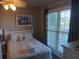Bedroom with queen bed, nightstand, and window at 106 W Arctic Ave # 1D, Folly Beach, SC 29439