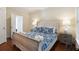 Bedroom with a wooden sleigh bed, hardwood floors, and neutral decor at 7 33Rd Ave, Isle of Palms, SC 29451