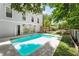 Relaxing backyard with refreshing pool, mural, and lush landscaping at 7 33Rd Ave, Isle of Palms, SC 29451