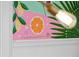 Close-up of a vibrant tropical-themed mural featuring citrus fruits and hibiscus flowers at 7 33Rd Ave, Isle of Palms, SC 29451