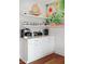 Well-equipped coffee bar with white cabinets, a tropical mural, and plenty of storage at 7 33Rd Ave, Isle of Palms, SC 29451