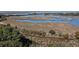 Aerial view of the property and surrounding marsh at 252 Pelican Flight Dr, Dewees Island, SC 29451