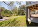 Landscaped backyard with elevated deck and access to wooded area at 1157 Oak Bluff Ave, Charleston, SC 29492