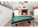 Fun game room features a pool table, wall mounted TV, and ample storage at 8217 Little Sydneys Way, North Charleston, SC 29406