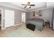 Spacious main bedroom with king-size bed, grey walls and a ceiling fan at 8217 Little Sydneys Way, North Charleston, SC 29406