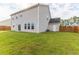 Backyard view of a beige two story house with a storage shed at 2035 Triple Crown Ln, Ridgeville, SC 29472