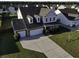 Aerial view of a two story house with a three-car garage and large yard at 2035 Triple Crown Ln, Ridgeville, SC 29472