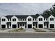 Row of new townhouses with white siding and black roofs at 212 Greenling St, Goose Creek, SC 29445