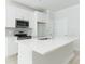 White kitchen island with sink and stainless steel appliances at 105 Equestrian Ct, Summerville, SC 29486
